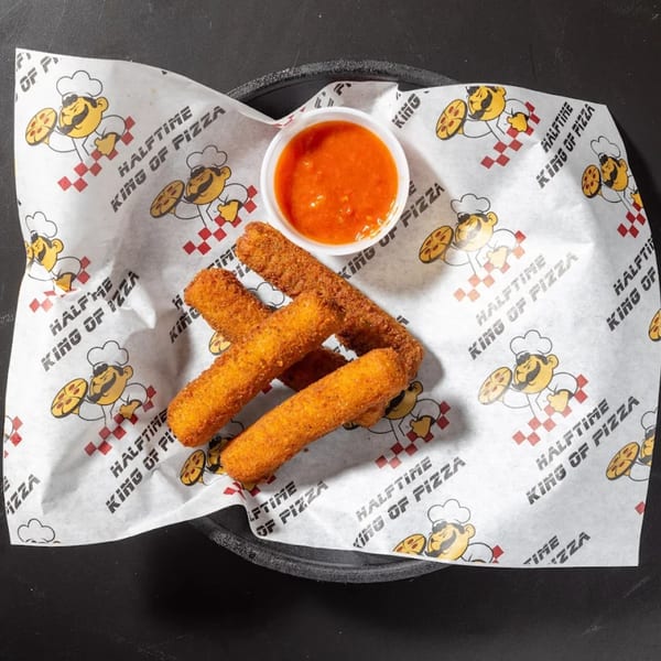 Four golden-brown mozzarella sticks and a cup of marinara sauce on Halftime Pizza branded paper.